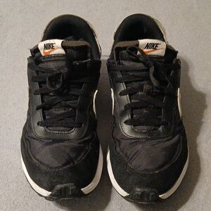 Nike Black Sneakers with White Midsoles and Orange Swoosh